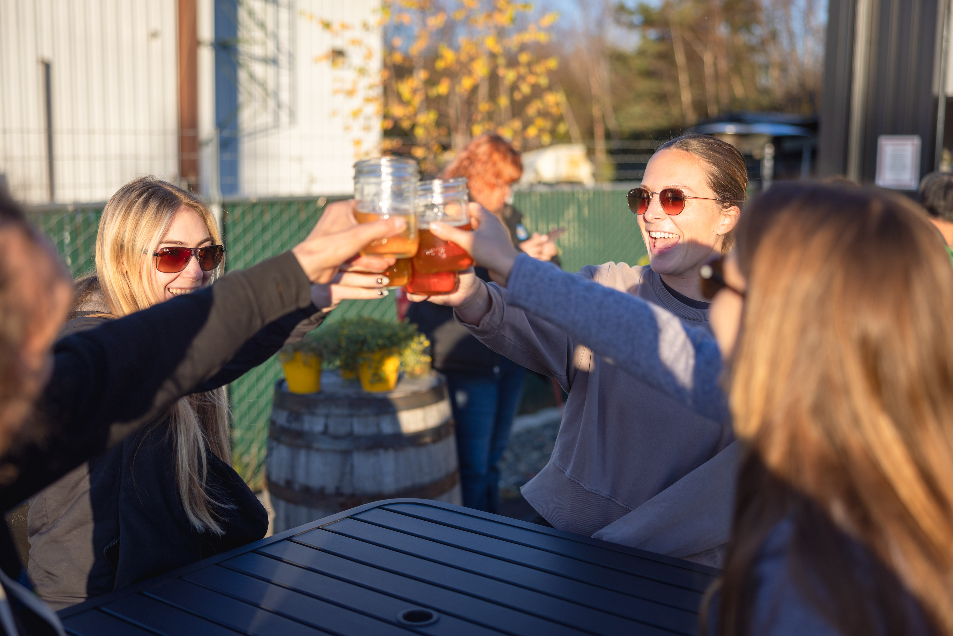 Friends toasting at the Zip Cider taproom